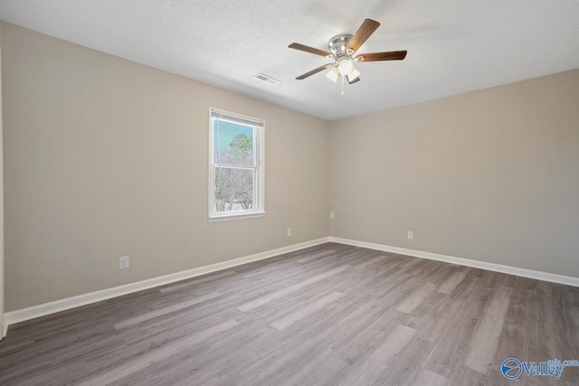1816 Devonshire Dr SE, Decatur, AL 35601 - unfurnished room with ceiling fan, wood finished floors, baseboards, and a textured ceiling