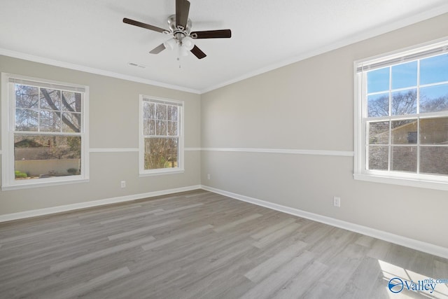 1816 Devonshire Dr SE, Decatur, AL 35601 - spare room featuring healthy amount of natural light, wood finished floors, ornamental molding, baseboards, and ceiling fan
