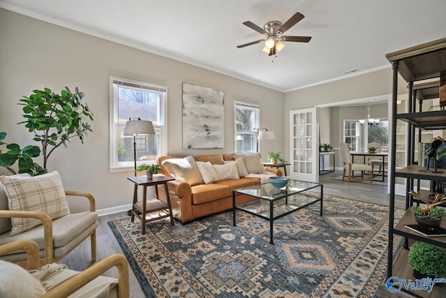 1816 Devonshire Dr SE, Decatur, AL 35601 - living room featuring wood finished floors, a ceiling fan, ornamental molding, a chandelier, and baseboards