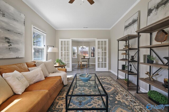 1816 Devonshire Dr SE, Decatur, AL 35601 - living room featuring wood finished floors, plenty of natural light, a ceiling fan, crown molding, and a chandelier