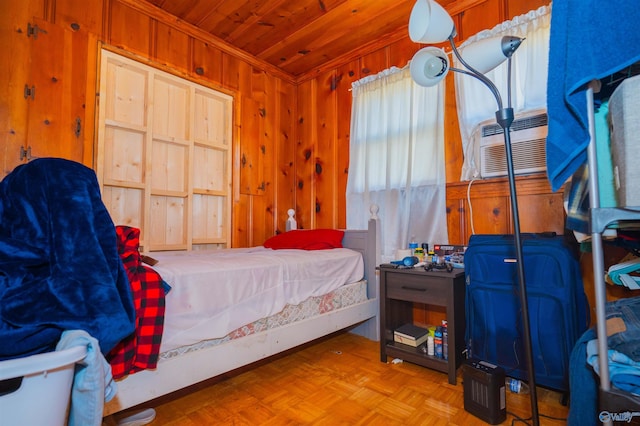 bedroom featuring light parquet flooring, crown molding, wooden ceiling, and wood walls