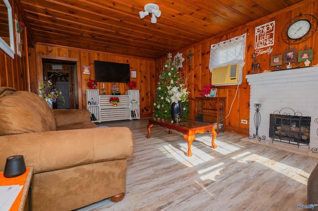 living room featuring wood ceiling, cooling unit, wood-type flooring, and wooden walls