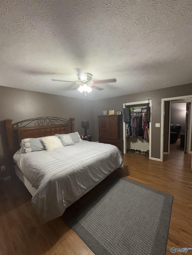 bedroom featuring dark hardwood / wood-style floors, a textured ceiling, a closet, and ceiling fan