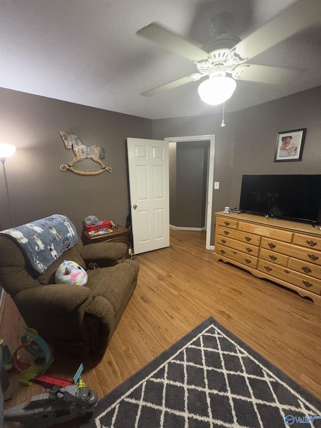 living room with wood-type flooring and ceiling fan