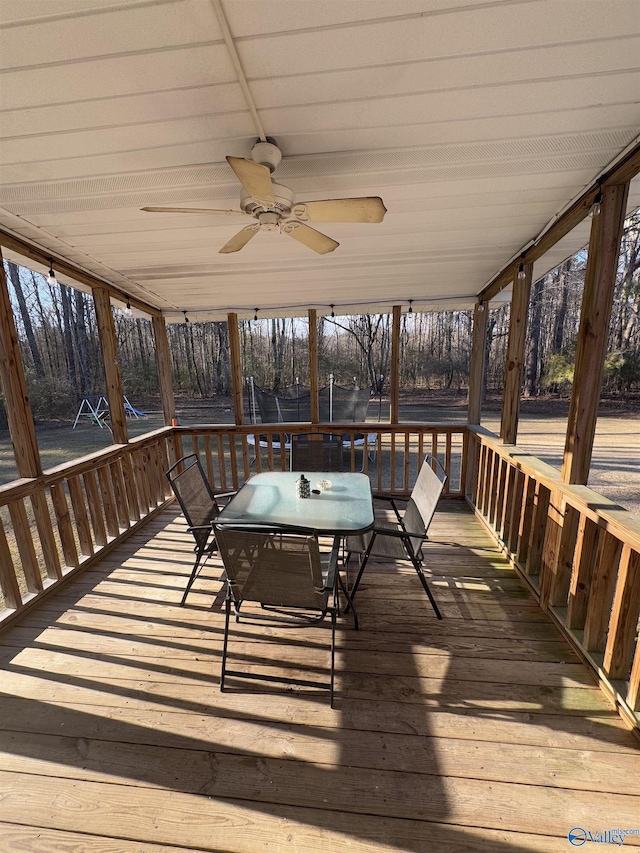 wooden terrace with a trampoline and ceiling fan