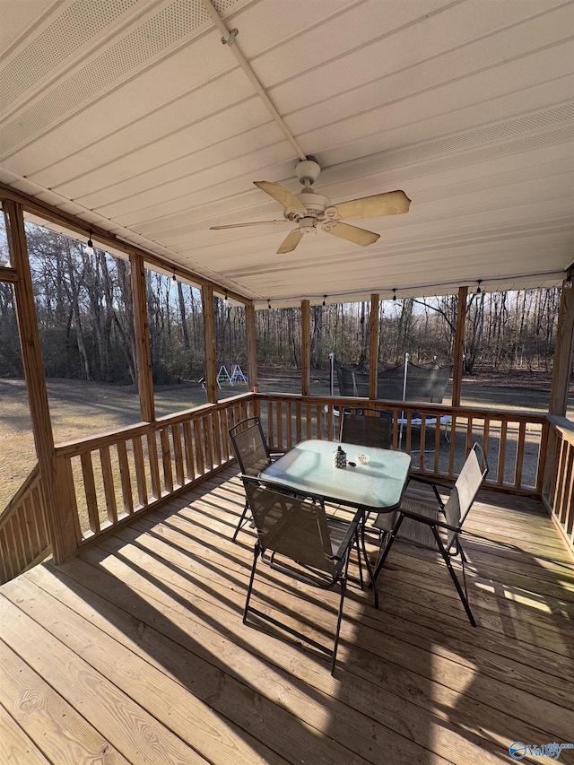 sunroom featuring ceiling fan