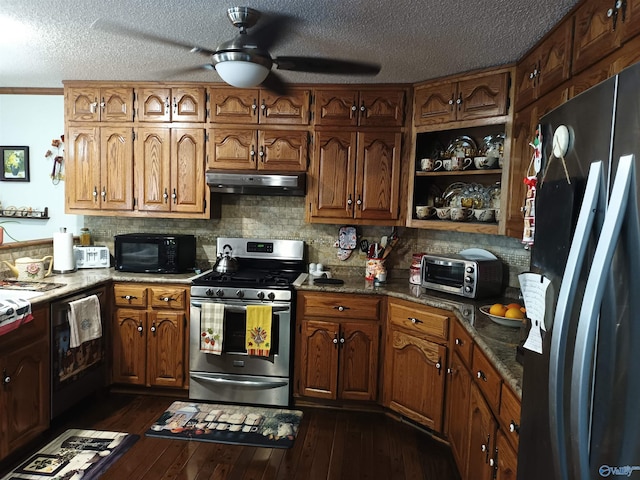 kitchen featuring ceiling fan, appliances with stainless steel finishes, dark hardwood / wood-style floors, a textured ceiling, and decorative backsplash