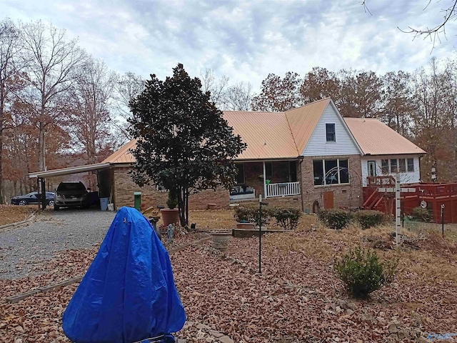 view of front of home featuring a carport and a porch