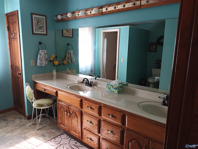 bathroom featuring tile patterned floors, vanity, and toilet