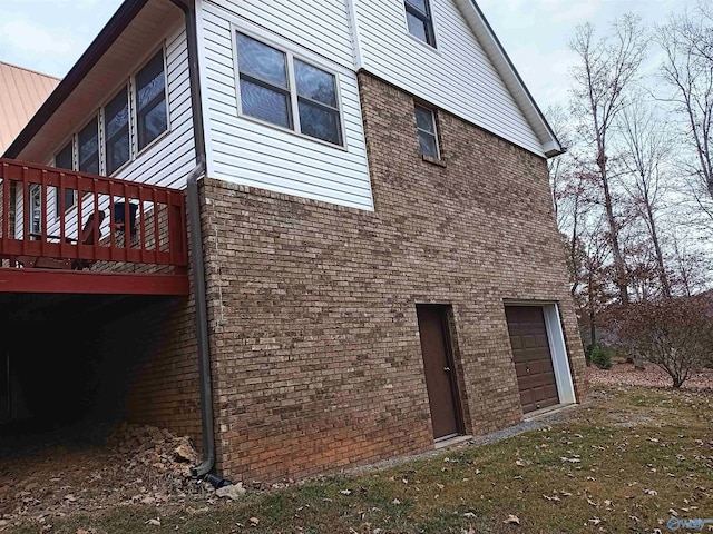 view of home's exterior with a garage and a wooden deck