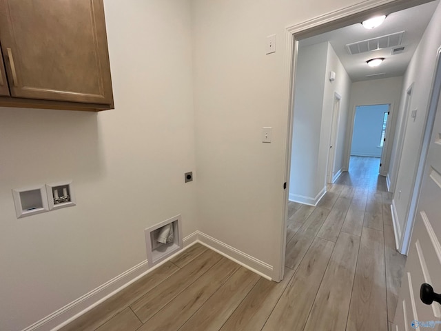 laundry area with hookup for an electric dryer, cabinets, light wood-type flooring, and hookup for a washing machine