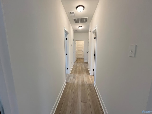 hallway with light wood-type flooring