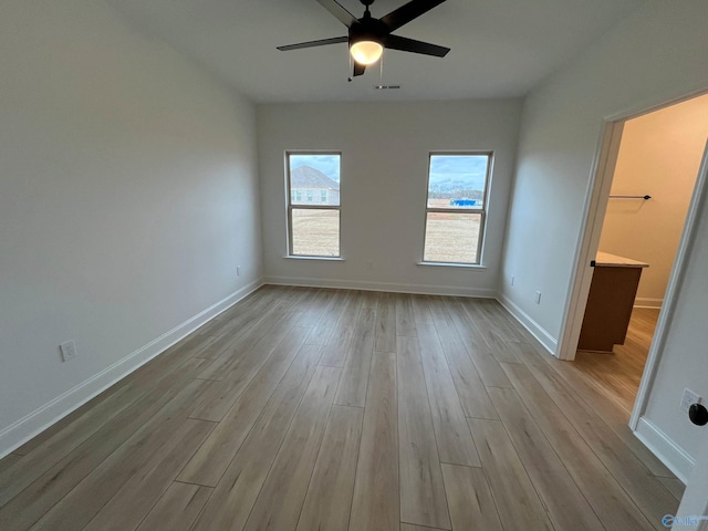 spare room featuring ceiling fan and light hardwood / wood-style flooring