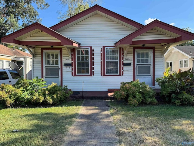 bungalow-style house with a front lawn