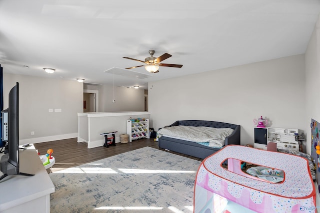 bedroom featuring ceiling fan, dark wood-type flooring, attic access, and baseboards