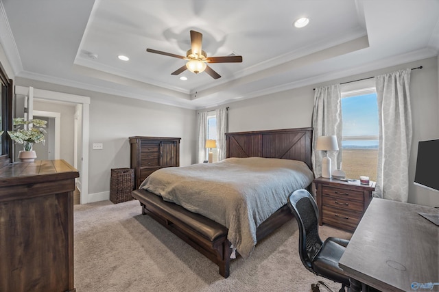 bedroom featuring crown molding, baseboards, a raised ceiling, and light colored carpet