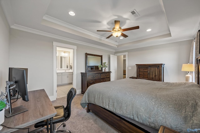 bedroom featuring ornamental molding, light colored carpet, a raised ceiling, and visible vents