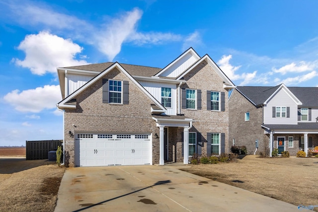 view of front of home with brick siding, concrete driveway, an attached garage, central AC unit, and board and batten siding