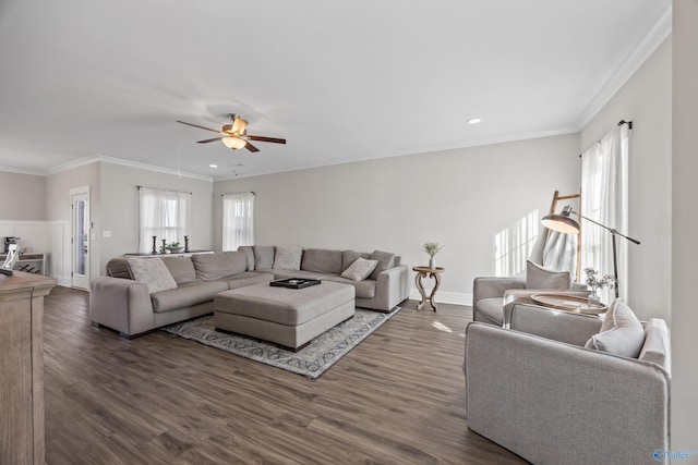 living room featuring dark wood-style floors, crown molding, and plenty of natural light