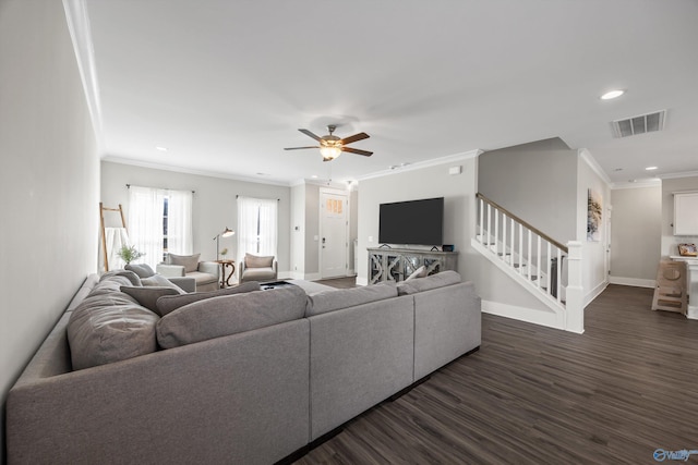 living area with visible vents, baseboards, ornamental molding, stairway, and dark wood finished floors