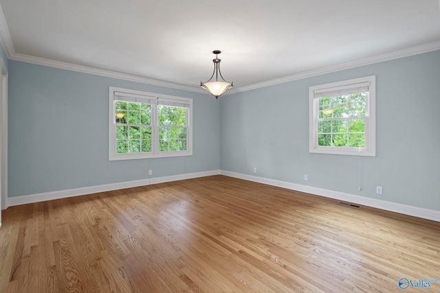 6824 Criner Rd SE, Huntsville, AL 35802 - empty room with healthy amount of natural light, ornamental molding, and wood finished floors