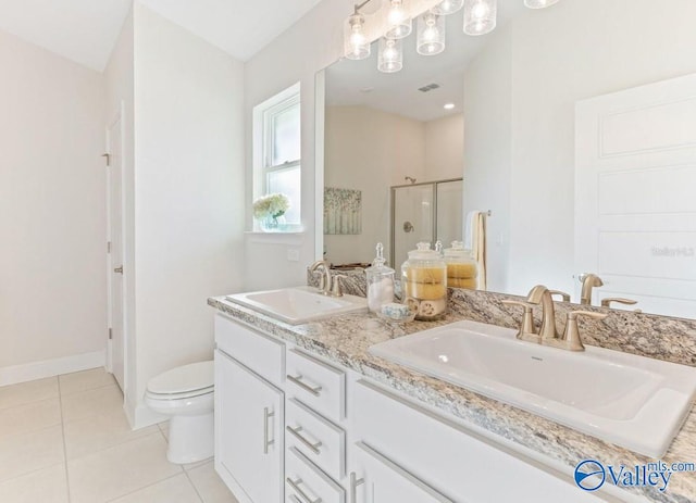 bathroom with tile patterned floors, vanity, toilet, and walk in shower