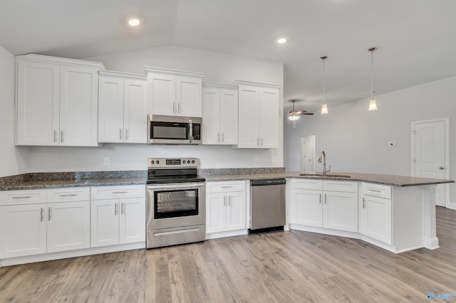 kitchen with stainless steel appliances, white cabinetry, hanging light fixtures, and sink