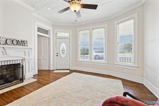 entryway featuring dark hardwood / wood-style flooring, ceiling fan, and ornamental molding