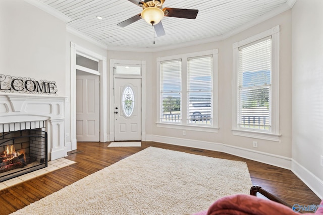 entrance foyer featuring dark hardwood / wood-style floors, ceiling fan, and ornamental molding