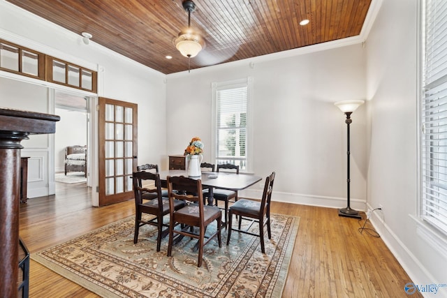 dining room with crown molding, french doors, wood ceiling, and light hardwood / wood-style floors