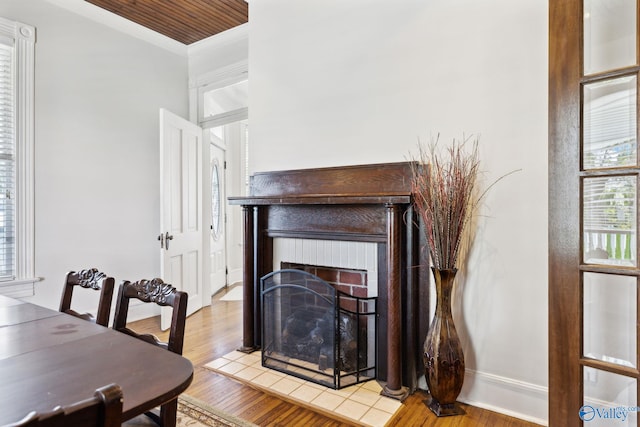 dining space with a fireplace and light wood-type flooring