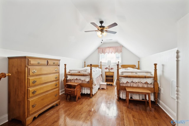 bedroom featuring wood-type flooring, vaulted ceiling, and ceiling fan