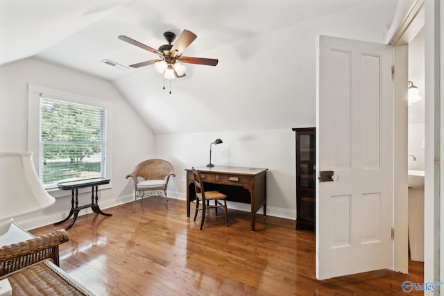 living area with wood-type flooring, vaulted ceiling, and ceiling fan