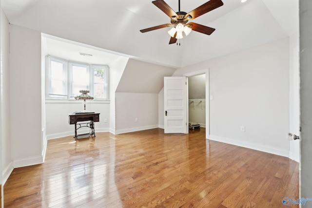 bonus room featuring ceiling fan, light hardwood / wood-style floors, and vaulted ceiling