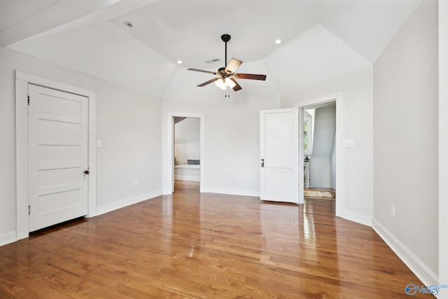 spare room featuring ceiling fan, hardwood / wood-style floors, and vaulted ceiling