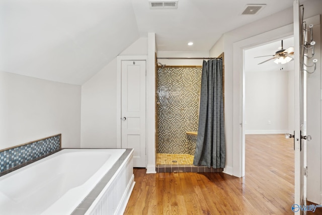 bathroom featuring wood-type flooring, separate shower and tub, ceiling fan, and lofted ceiling