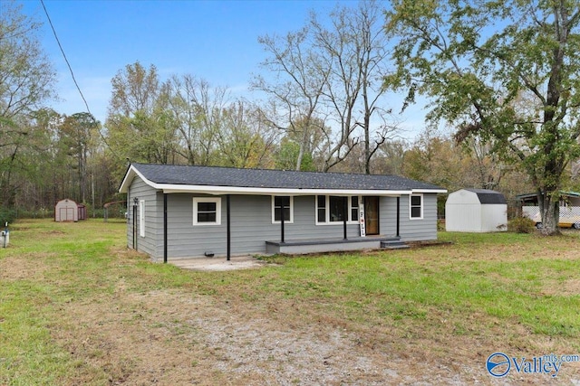 single story home with a front lawn and a storage unit