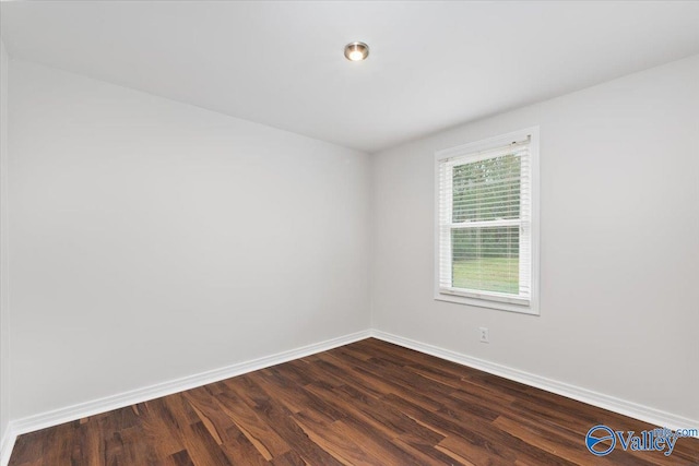 unfurnished room with dark hardwood / wood-style floors