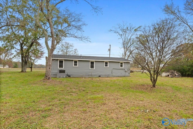 back of house featuring a lawn and cooling unit