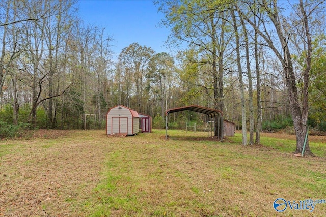 view of yard with a storage unit and a carport