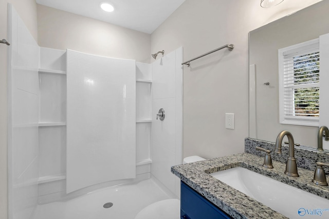 full bath featuring a shower stall, vanity, and toilet