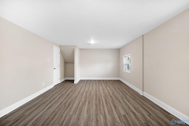 empty room featuring wood finished floors and baseboards