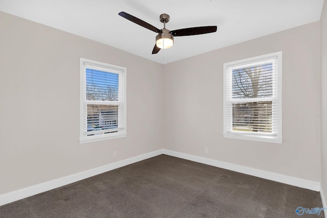 empty room with baseboards, a ceiling fan, and dark carpet