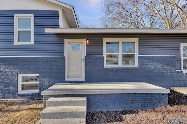 entrance to property with brick siding