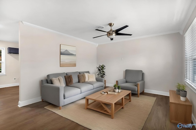 living area featuring wood finished floors, crown molding, a ceiling fan, and baseboards