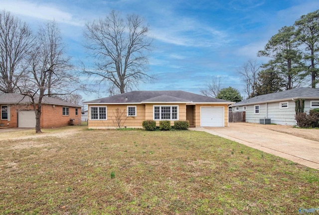 ranch-style home featuring a front yard, fence, driveway, an attached garage, and central air condition unit