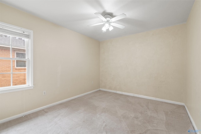 unfurnished room with baseboards, light colored carpet, and ceiling fan