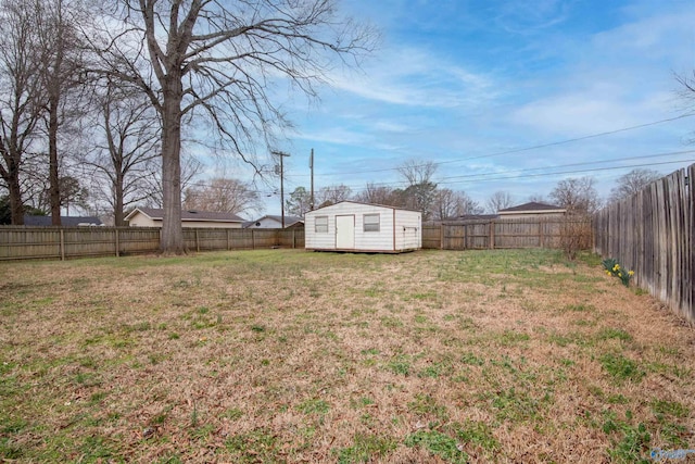 view of yard featuring an outbuilding, a storage unit, and a fenced backyard