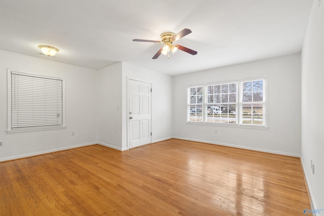 unfurnished room featuring light wood-type flooring, baseboards, and ceiling fan