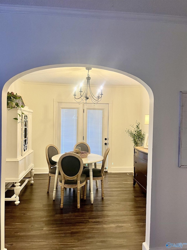 dining room featuring crown molding, an inviting chandelier, and dark wood-type flooring